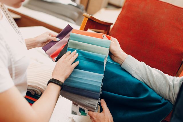 front view of a person reviewing sofa upholstery options