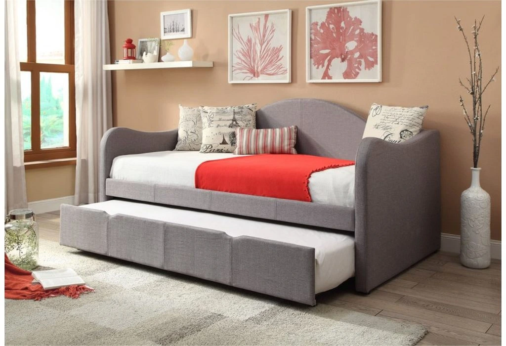 The Powell Home Fashions upholstered day bed with red bedding and décor throws 