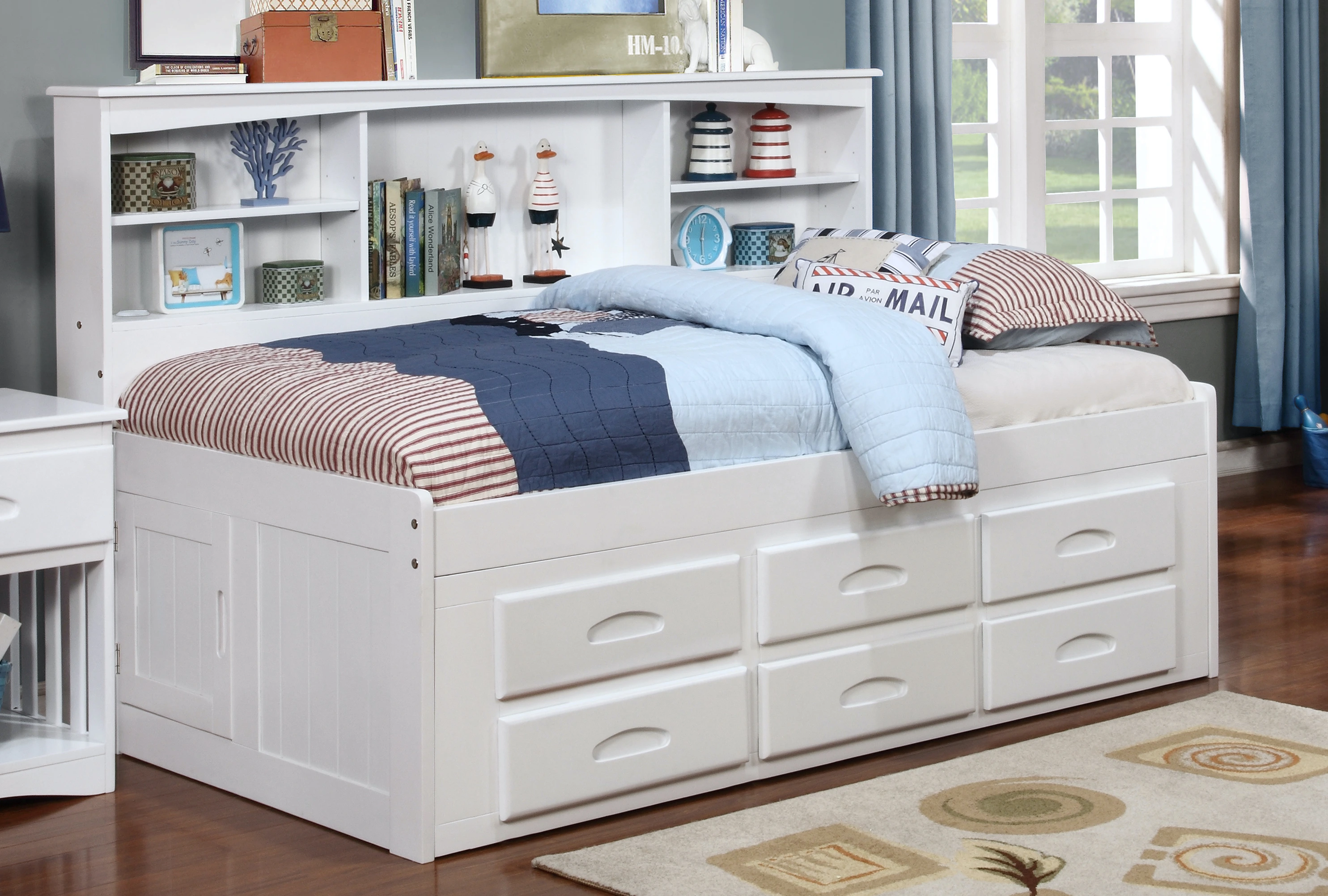 The Donco Kids white twin-size bookcase day ed with blue, red, and white bedding and décor 