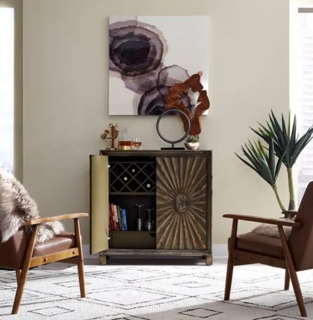 The Liberty Furniture Chaucer wine cabinet with bottles, books, and décor 