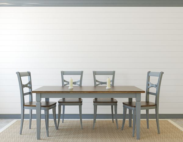 A dining room with a grey table set and a board and batten accent wall 