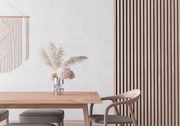 A boho chic dining room with macarame décor and a board and batten accent wall 