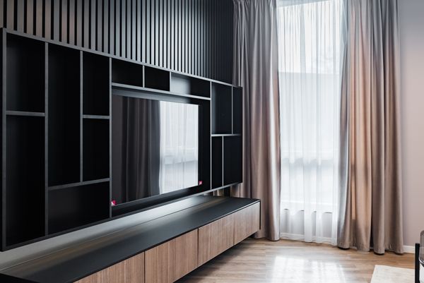 A custom wooden entertainment wall center with a large flat screen TV 