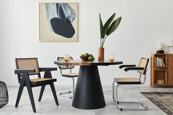 A modern cane dining chair in a modern dining room