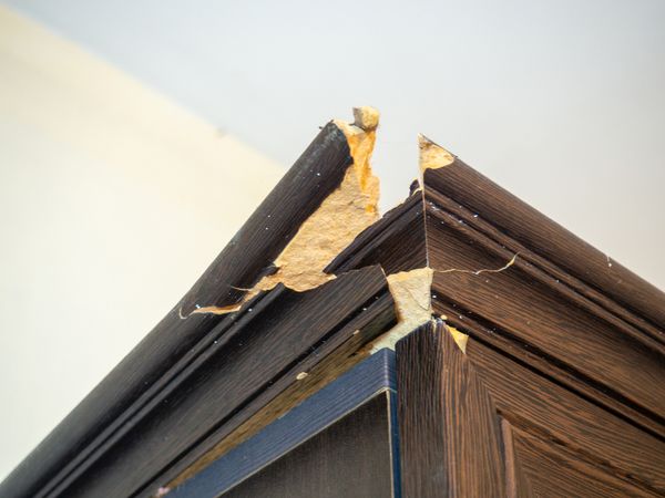 A close-up of a broken dresser corner 