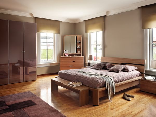 A modern bedroom featuring matching wooden furniture and décor 