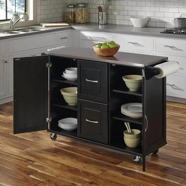 The homestyles Blanche collection black and stainless steel kitchen island with dinnerware and décor 