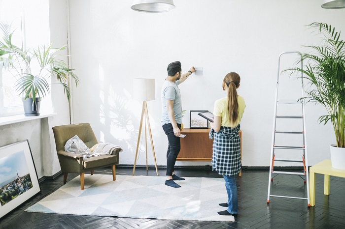 Couple choosing the right color for the walls, while renovating their living room.