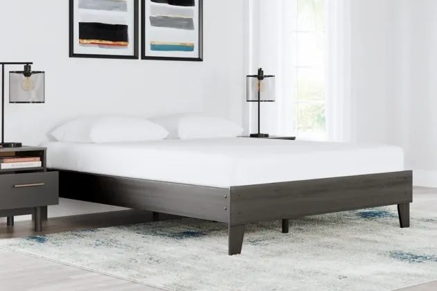 The Signature Design by Ashley Brymont collection queen-size panel bed with white bedding