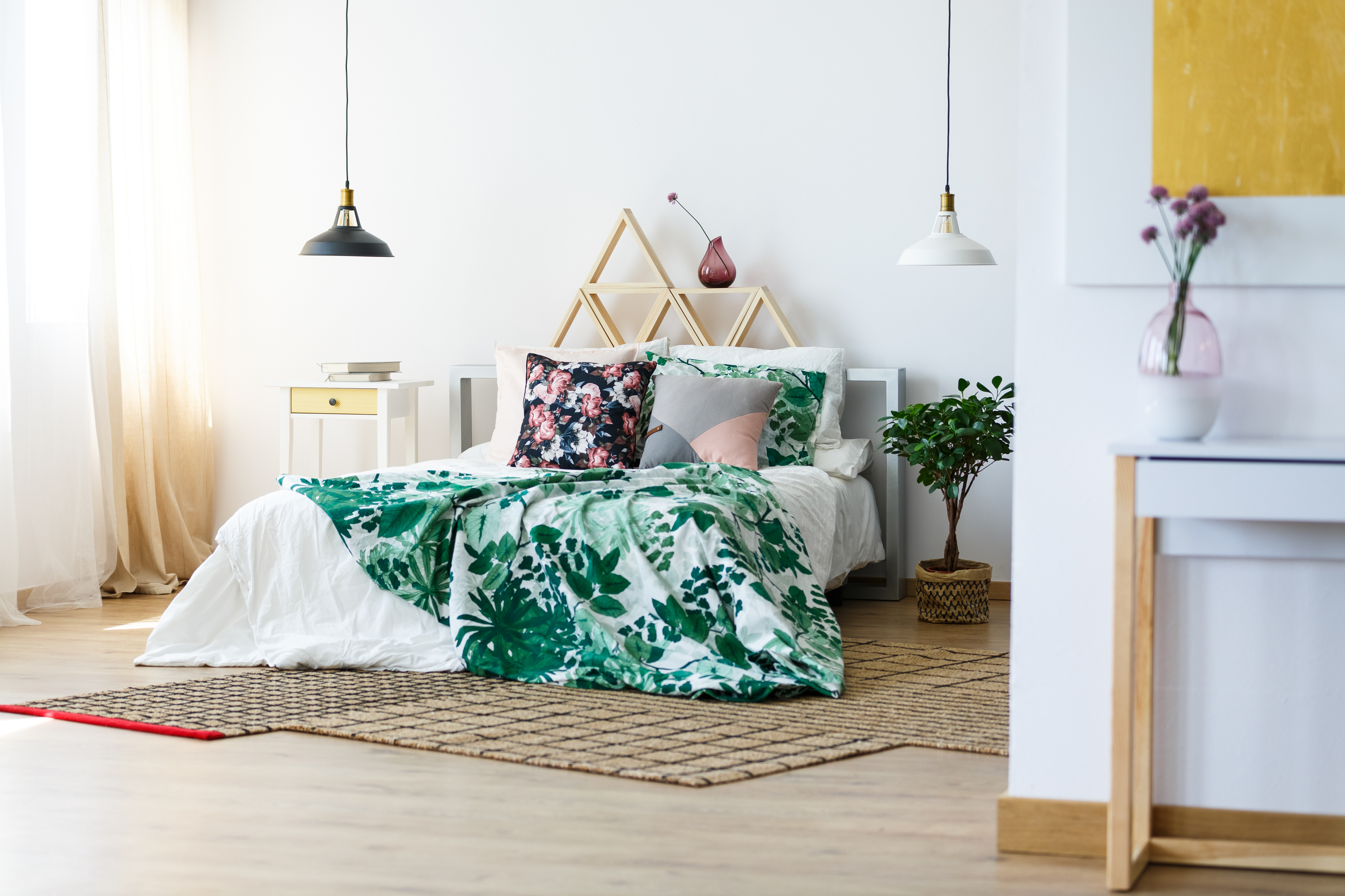 A bed with different bedding in floral patterns 