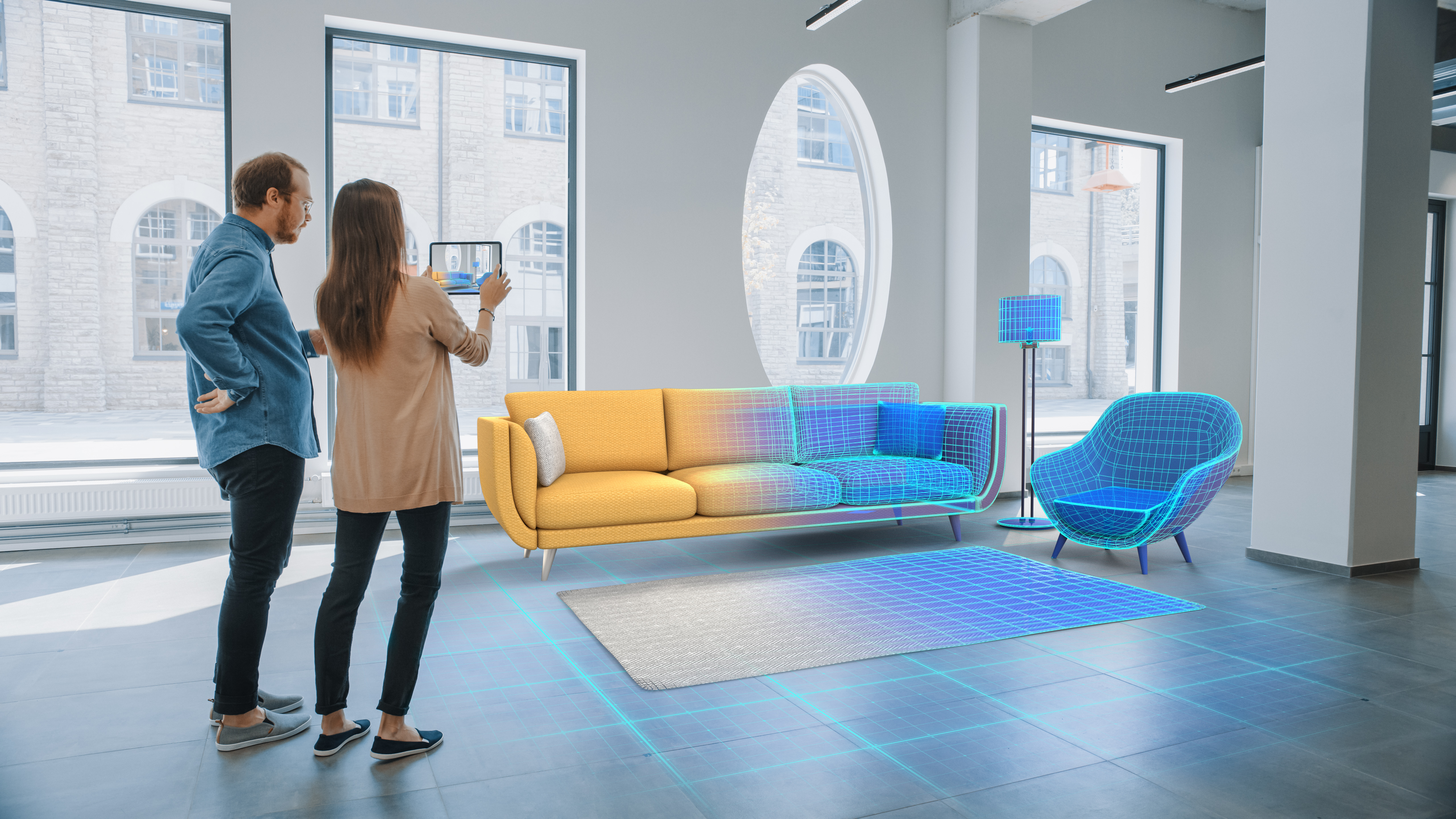 A couple using a tablet to design a blueprint for a living room 