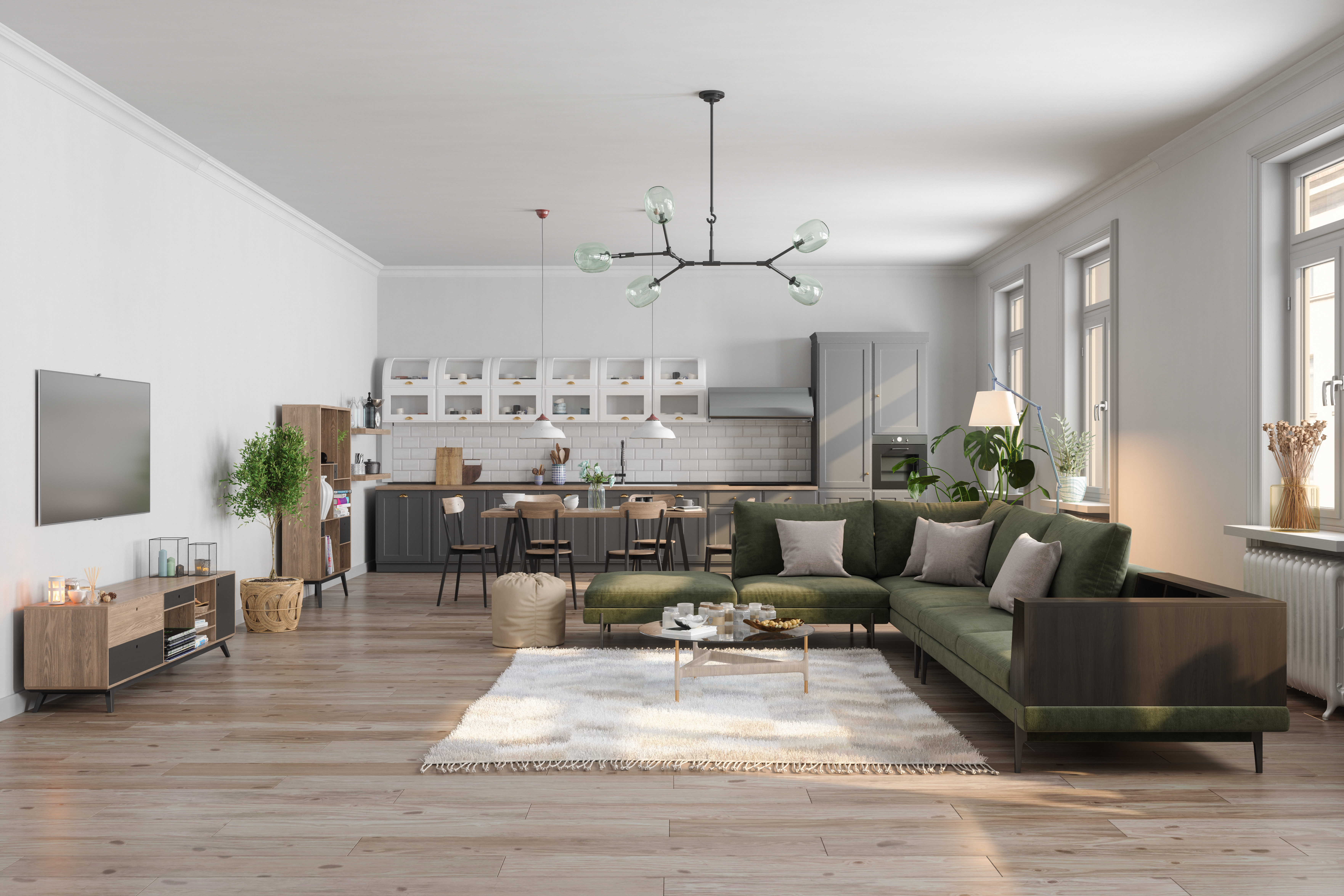 An open concept living room with a green sectional and wooden furniture pieces 