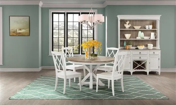 The Riverside Furniture Myra collection table with compatible collection pieces in a sage-themed dining room 