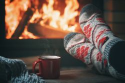  A wide shot of winter socks with a fireplace in the background