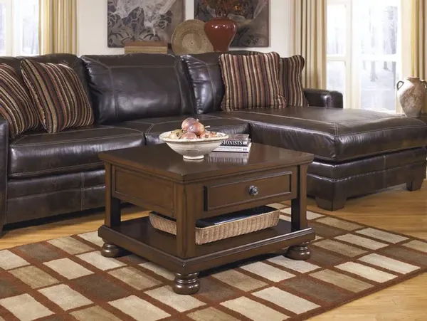 The Signature Design by Ashley Porter collection dining table in a living room 