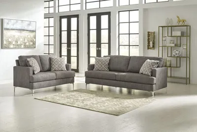 The Signature Design by Ashley Arcola collection 2-piece sofa loveseat set in a modern living room 