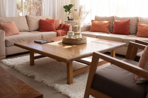 A white sofa and loveseat with earth tone décor 