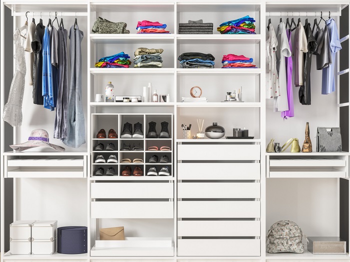 Very organized closet with separate compartments for clothing, shoes, and other storage. 