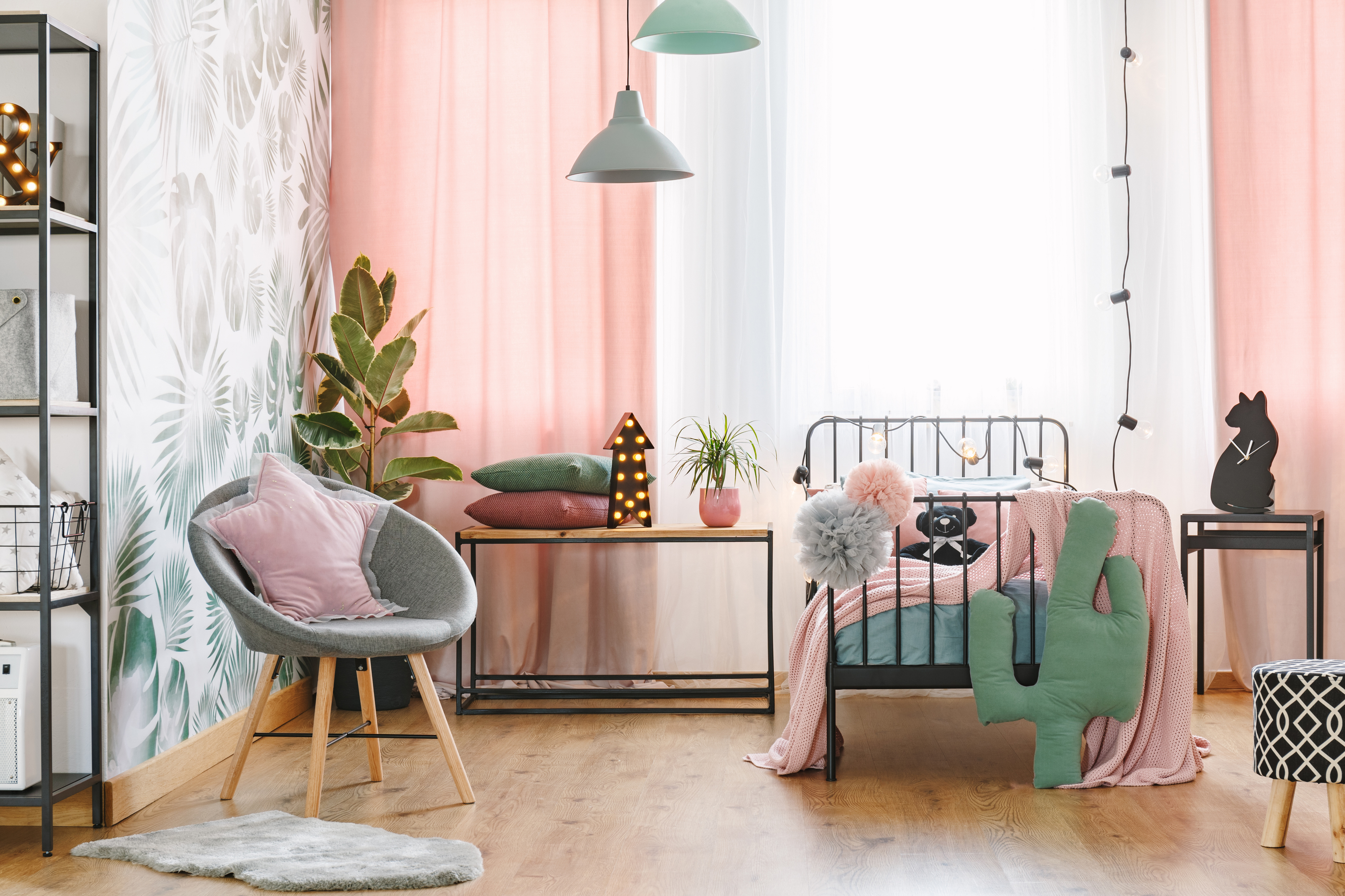 A pink and green theme girls bedroom with décor and furniture  
