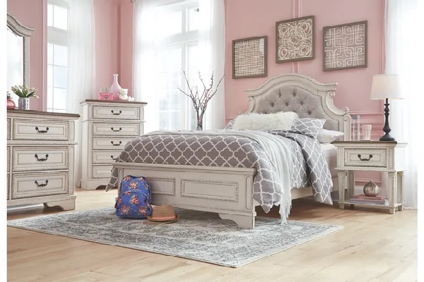 The Signature Design by Ashley Realyn collection bedroom furniture with pink décor and walls 