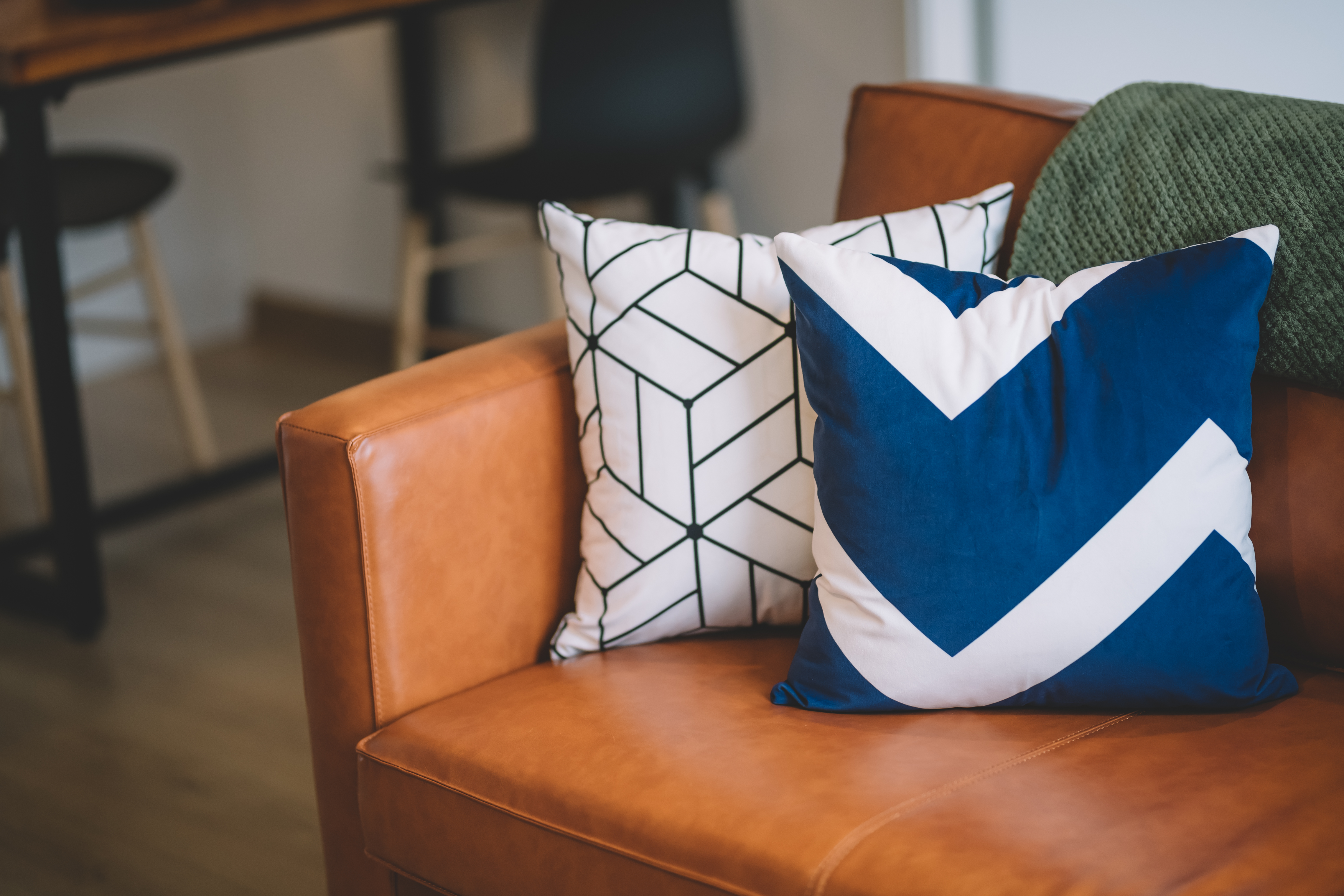 A leather sofa with a variety of accent throw pillows 