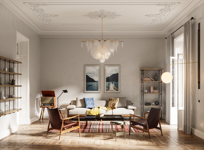 Image of a modern living room with sofa set, arms chairs, wall paintings and beautiful chandelier.