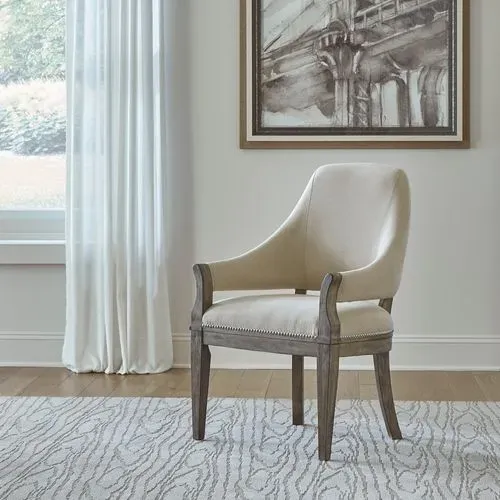 The Liberty Furniture Westfield Havana collection dining chair in against a wall with a portrait 