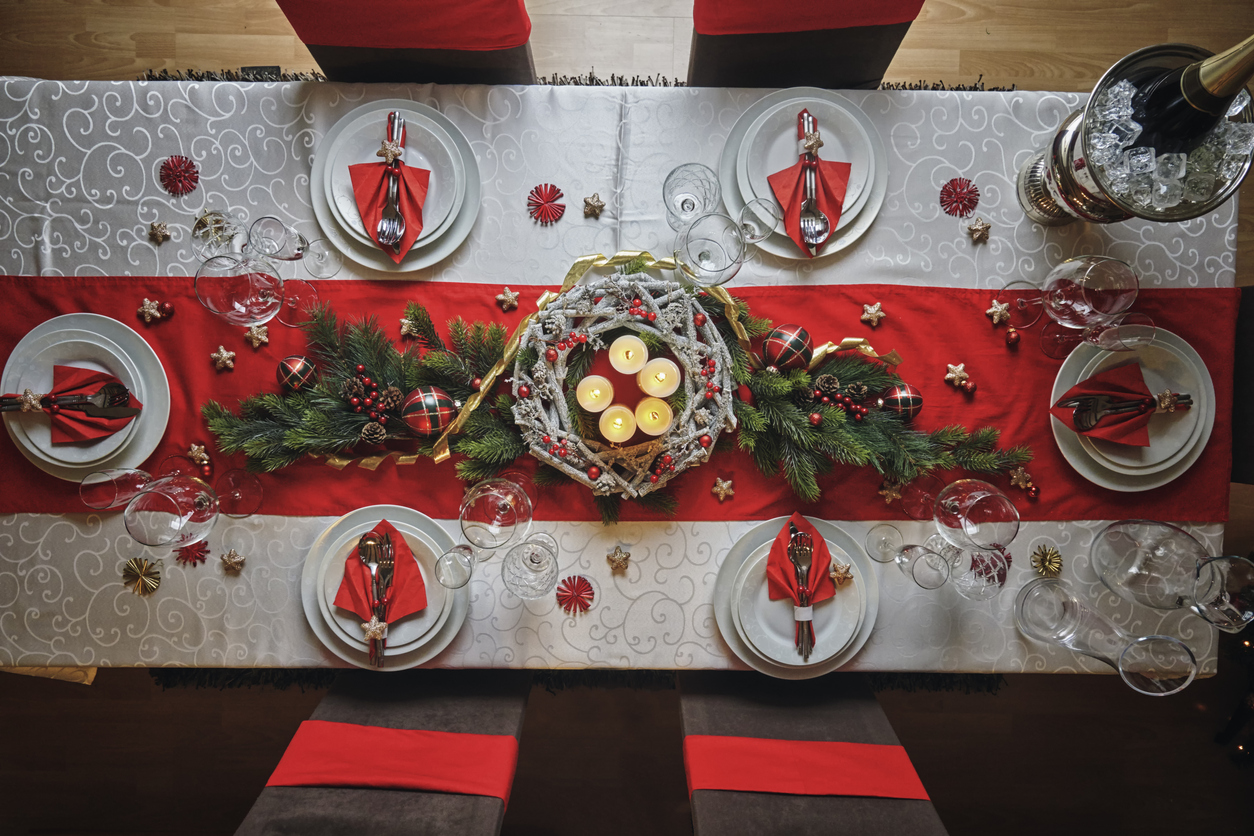 decorated table for Christmas dinner with candles and Christmas ornaments