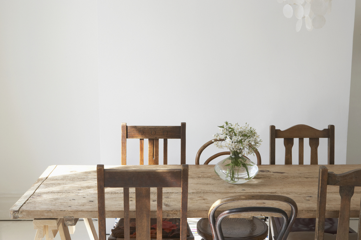 empty dining room with rectangular table and eclectic chairs