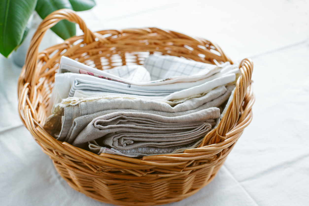 kitchen textiles made of cotton and linen in a wicker willow basket