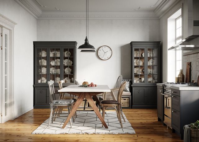modern greige dining room with a regtangular table, mix matched chairs, and a dark grey dining hutch