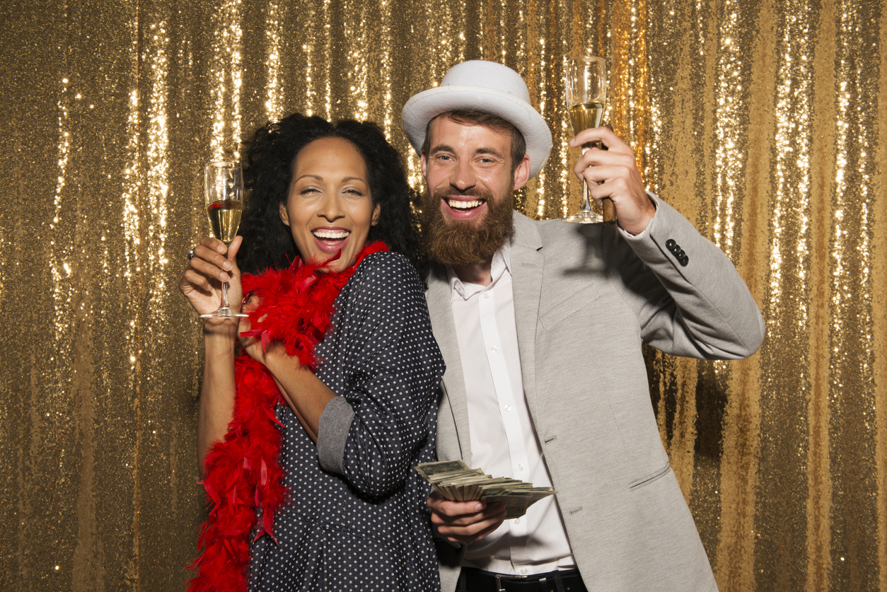 portrait of smiling couple holding champagne flutes at party