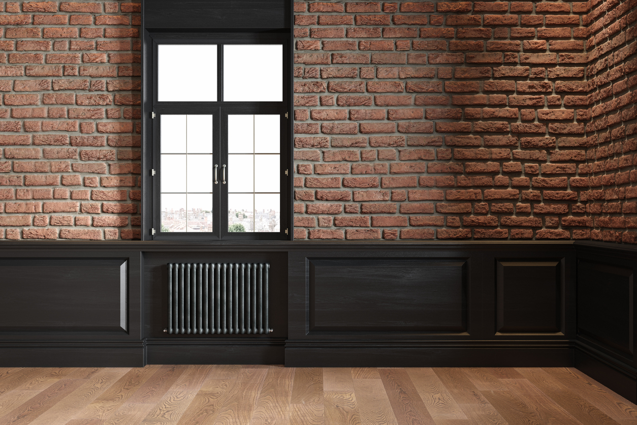 black wall molding and window against brick wall