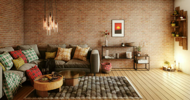 dimly lit living room with a desk, rug, coffee table and a couch decorated with multiple plaid pillows