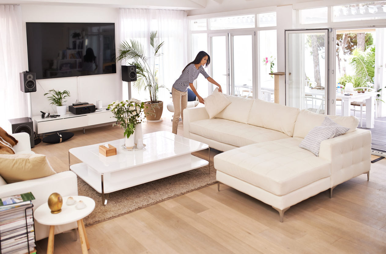 young woman tidying her house