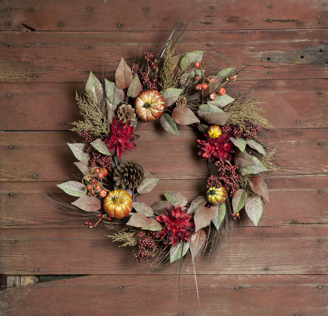 festive and rustic holiday wreath hanging on old wood door