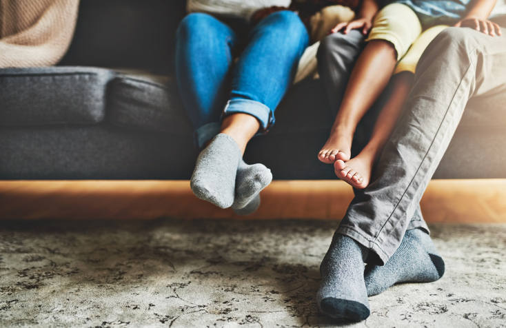 feet of family sitting on a sofa