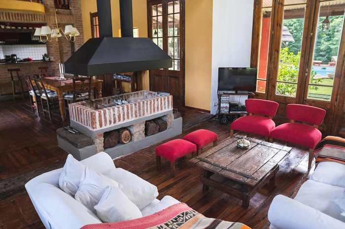 Spread out living room of a rustic, wooden house.
