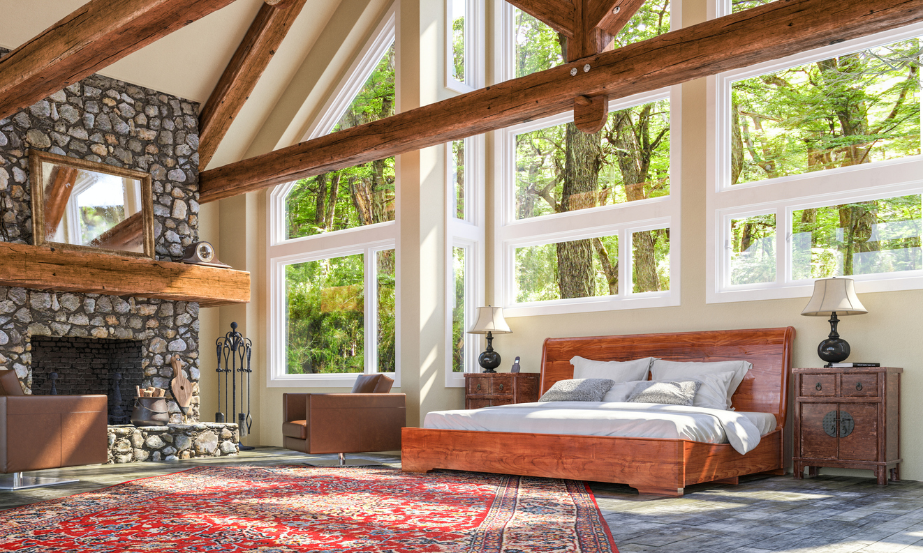open room with stone fireplace and wooden bed