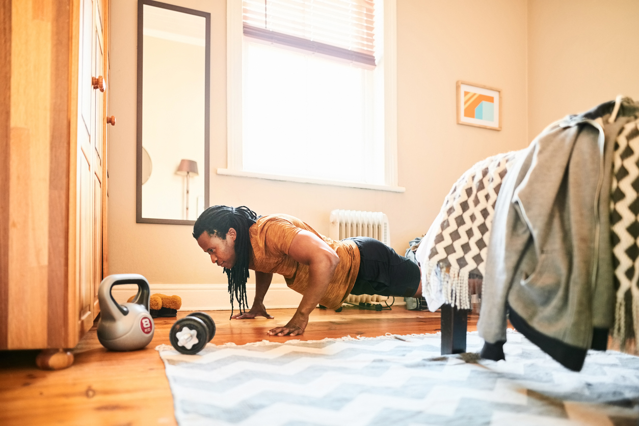 Man does pushups in his home gym in the guest bedroom 