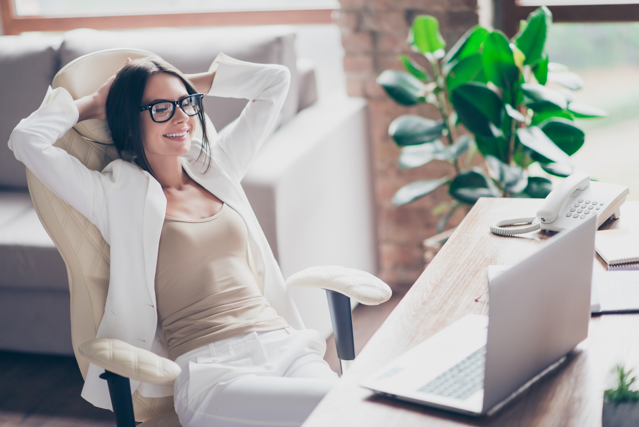 Woman smiling and relaxing in an office chair