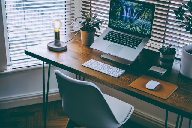 Front view of a standard desk in front of a window 