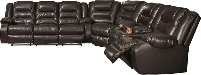 Stock image of a large brown leather l shaped sectional sofa.