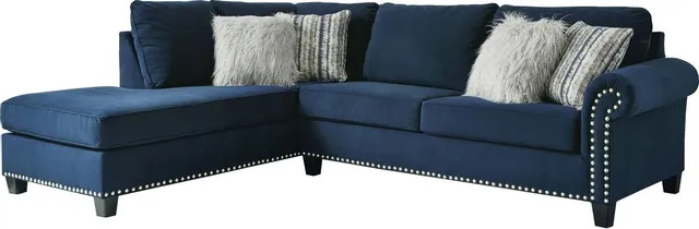 Stock image of a blue interior l shaped sectional sofa with white accent pillows. 