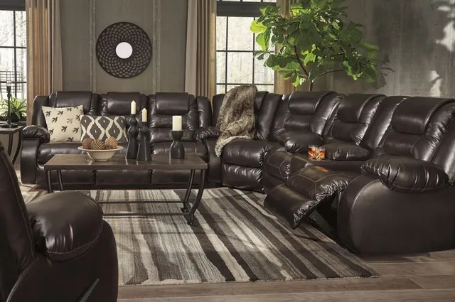 Contemporary living room with a large brown leather l shaped sectional sofa. 