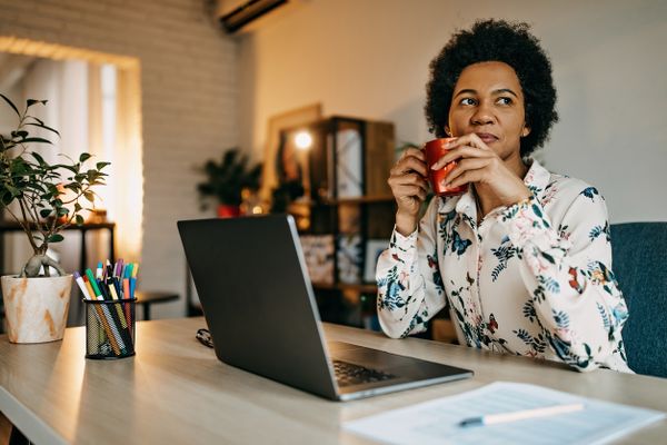 Working at Home Desk Woman Drinking Coffee at Her Home Office Desk