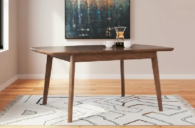 The Signature Design by Ashley Lyncott collection extendable dining table with décor 