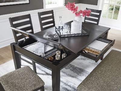 The Signature Design by Ashley Ambenrock collection extendable table with décor 