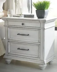 The Benchcraft Kanwyn collection nightstand with decor