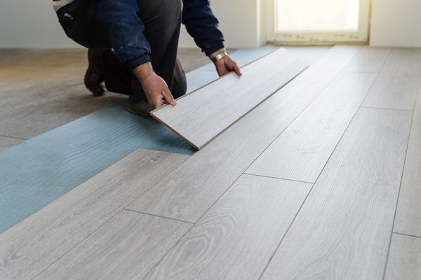  A man installing laminate flooring 